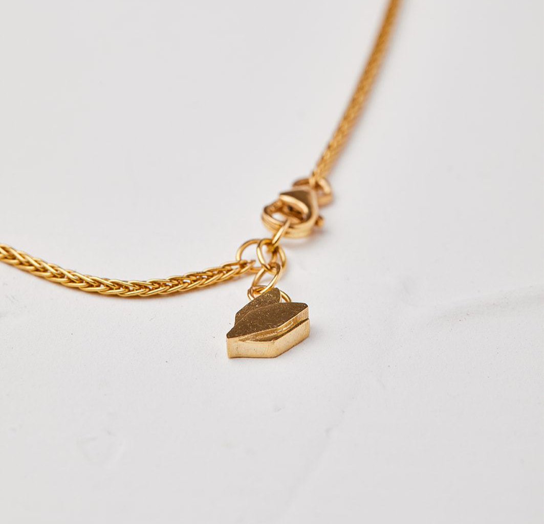 Gold Necklace With a Cyclamen Pendant in a Bracket