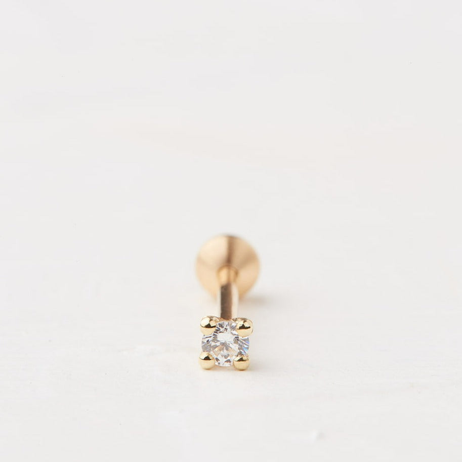 Square piercing with a round stone