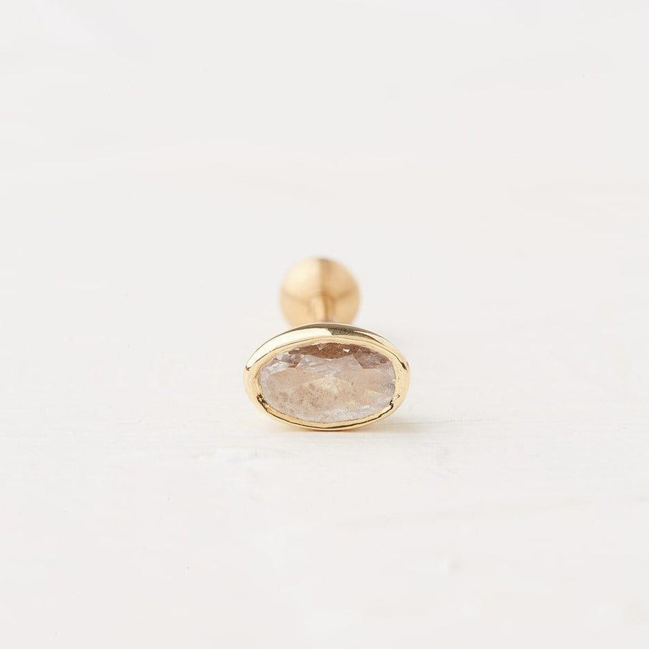 Piercing With an Oval Stone in a Gold Frame