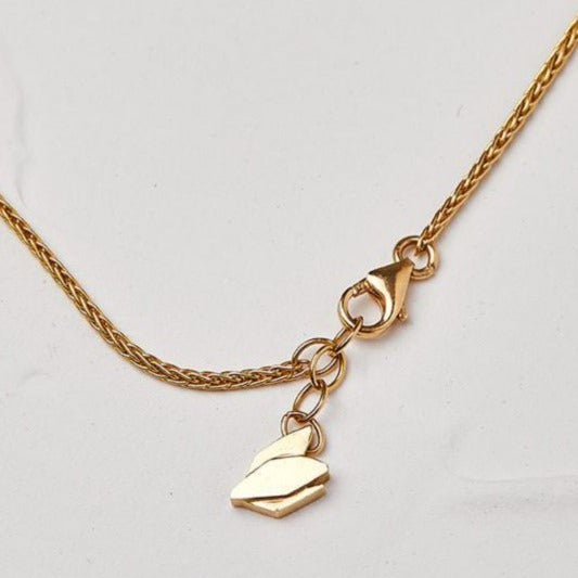 Gold Necklace With a Cyclamen Pendant in a Bracket