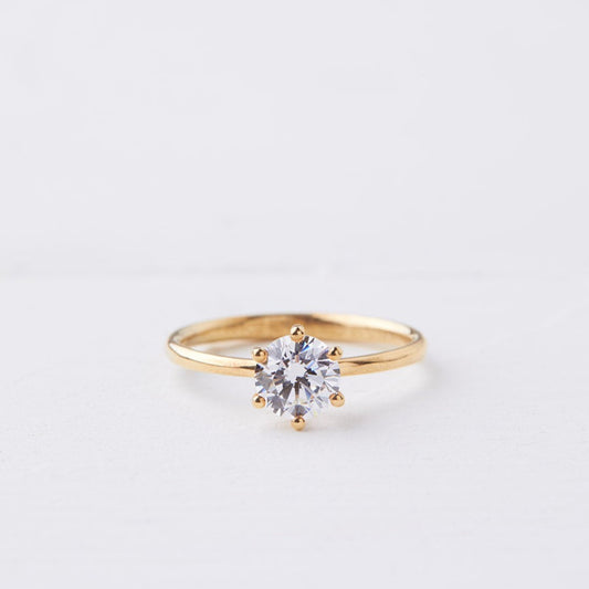 Gold engagement ring with round diamond
