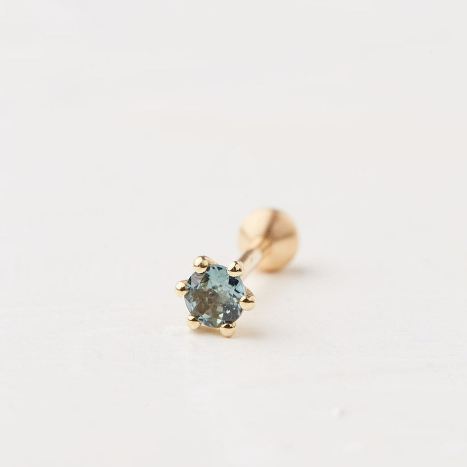 Square piercing with a round stone